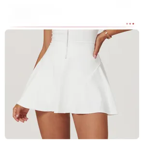 Detailed view of white A-line tennis dress with high waist and front metal zipper closure