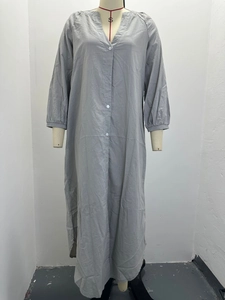 Detail view of the gray linen-style long sleeve button-up maxi dress on a mannequin