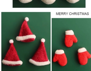 Detail view of handmade red and white wool felt Christmas hat and glove decorations