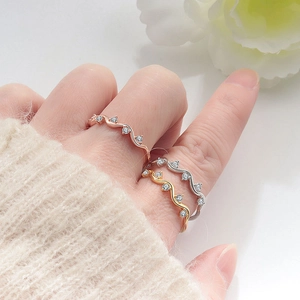 Minimalist wave rings in rose gold, gold, and silver with tiny zircon stone accents