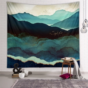 Detail of mountain tapestry with golden outlines and ink landscape on a white wall
