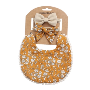 Detailed set of floral cotton baby bib with lace edges and two matching bow headbands