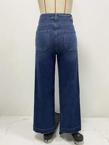 Detail view of high waist wide leg dark blue denim pants with classic back pockets design