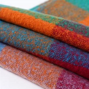 Close-up of multicolor plaid cashmere-like scarf showing soft brushed fabric texture
