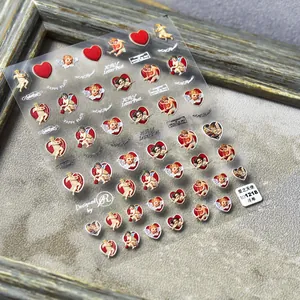 Makro-Detail von 5D-geprägten Nagelaufklebern mit roten Herzen und Amoretten