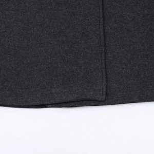 Close-up of high-quality dark gray wool blend long coat showing fine stitching detail