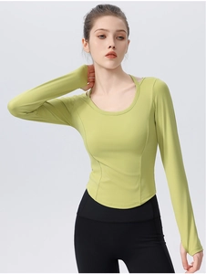 Detail of avocado green yoga top with thumb holes and slim-fit curved hem design