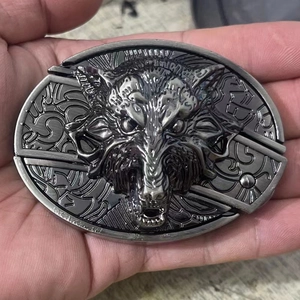 Macro detail of gunmetal wolf head belt buckle with integrated folding knife tool