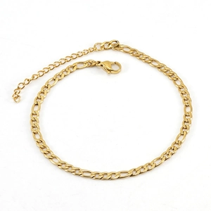 Close-up of golden Figaro chain with lobster clasp and adjustable extension link detail