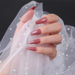 Glossy long coffin press-on nails in dusty rose pink, shown with elegant pearl mesh