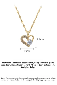 Detail view of gold heart pendant necklace showing 1.9cm by 2.2cm dimensions and materials