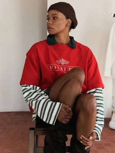 Retro style red 100% cotton short sleeve t-shirt layered with green striped shirt