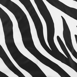 Close-up of zebra print fabric with high-contrast black and white stripes and soft texture