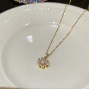 Elegant gold four leaf clover necklace with zircon pendant and sparkling crystal details