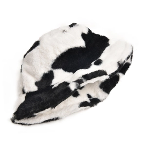 Close-up of soft faux fur texture on this stylish black and white cow print bucket hat