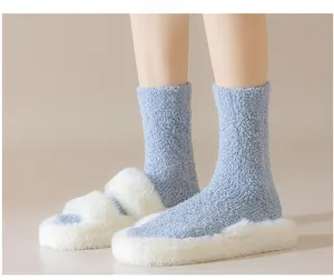 Close-up of fluffy light blue coral fleece socks paired with plush white slippers