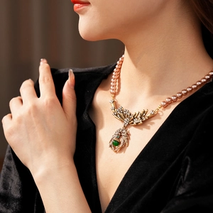 Vintage necklace with pearl strands and green gemstone spider pendant on model