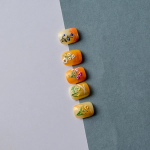 Macro shot of 5D embossed flower nail stickers with colorful floral relief patterns