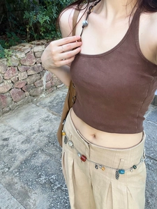 Detail of bohemian silver chain belt with colorful mineral beads and metallic pendants