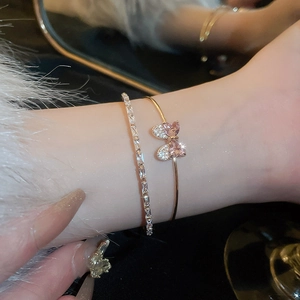 Elegant gold bow cuff bracelet set with sparkling pink and clear zircon crystals
