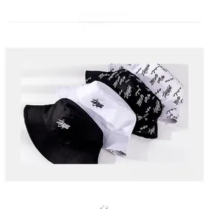 Detail showing various cotton bucket hats with solid colors and graffiti print patterns