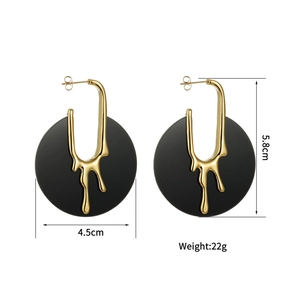 Detailed view of gold and black lava earrings with size dimensions 5.8cm by 4.5cm