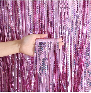 Close-up of pink laser metallic fringe curtain showing soft texture and rainbow shimmer