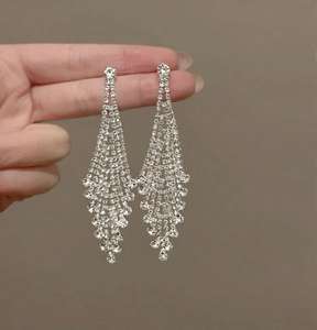 Silver needle tassel earrings featuring dense rhinestones on long layered fringe