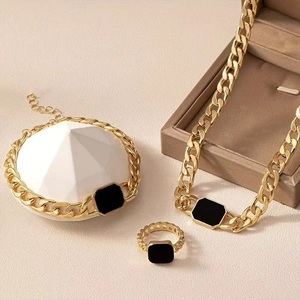 Chunky gold chain jewelry set with black rectangular accents including necklace and ring