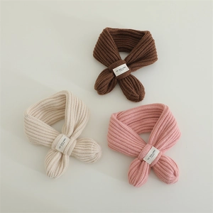 Detailed close-up showing the ribbed knit texture and woven label of baby scarves