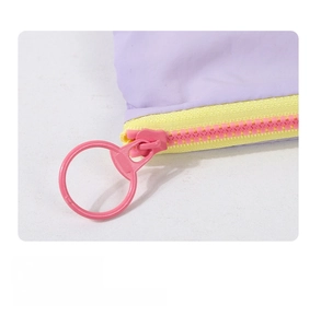 Detail of smooth pink ring zipper on pastel macaron fabric storage cosmetic pouch