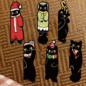 Set of 6 cute black cat bookmarks featuring diverse outfits like Santa and clown themes