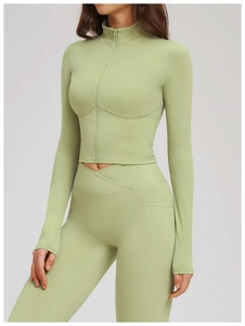 Detailed close-up showing the zipper closure and seam stitching on the yoga jacket