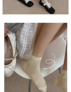 Detail of breathable silk protein socks with fine ribbed cuffs in light yellow