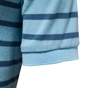 Detailed macro shot of teal and navy blue striped piqué cotton texture on polo shirt sleeve
