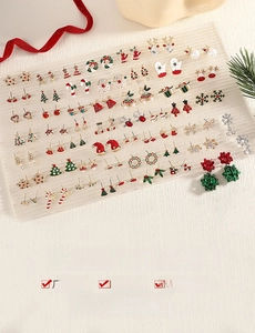 Close-up of alloy Christmas stud earrings set featuring reindeer, snowflakes and trees