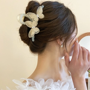 Detailed close-up of butterfly embroidery lace hair claw with elegant faux pearls