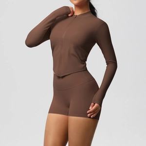 Detail view of coffee brown zip-up yoga jacket and high-waist shorts set on model