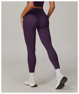 Rear view of dark purple high-waisted yoga pants showing lifting and slimming effect