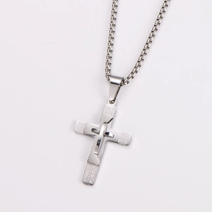 Detailed macro view of silver stainless steel triple cross pendant on box chain necklace