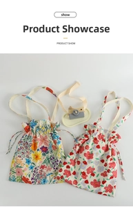 Flat lay of floral canvas tote bags with drawstring closure and vintage wooden props
