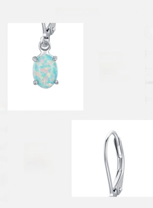Detail of s925 silver oval opal earrings with four-prong zircon setting and lever back
