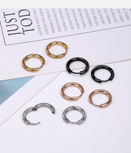 Polished stainless steel hoop earrings shown in gold, black, rose gold, and silver finishes