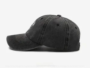 Close-up of charcoal gray washed cotton baseball cap with white New York embroidery