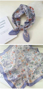 Detail of floral linen neck scarf with purple patterns and tied styling demonstration