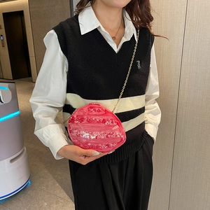 Pink marble shell acrylic evening bag with gold chain strap shown on model's shoulder