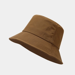 Classic dark brown bucket hat with decorative stitching on a clean gray background