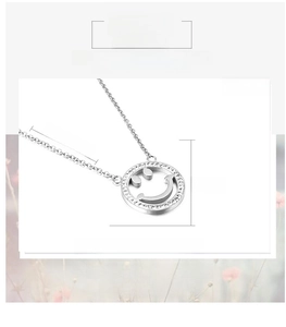 Detail of 20x20mm hollow smiley face pendant with inset crystals on a steel necklace