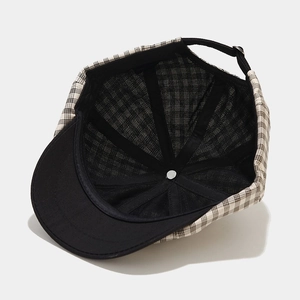 Vintage checkered newsboy hat with black brim and adjustable strap, 45-degree angle view