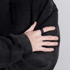 Detail view of men's titanium steel ring with blue and black woven chain texture